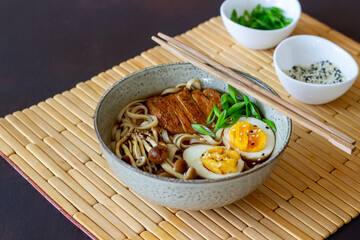 Ramen soup with noodles, pork, mushrooms and eggs. Japanese cuisine. Recipe.