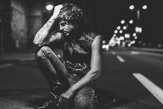 hangover, fashionable handsome drunk man in the middle of the highway
