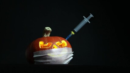 Halloween pumpkin with mask and syringe with yellow liquid, inoculation, on black background - Powered by Adobe