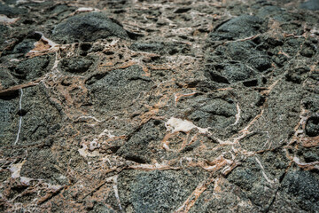 Colorful rock texture. Natural cracks void.