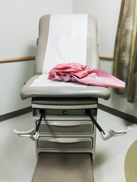 Gynecologist exam table with a pink exam gown