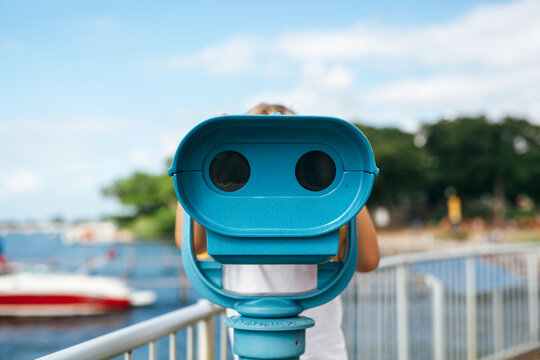 boy looking through coin operated binoculars
