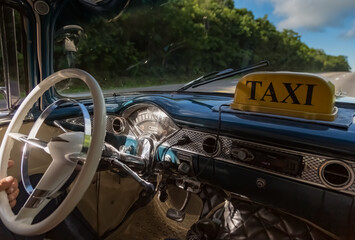A Taxi driving on a Cuban road.