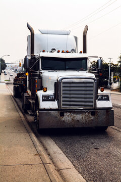 Large semi-truck by the kerb side.