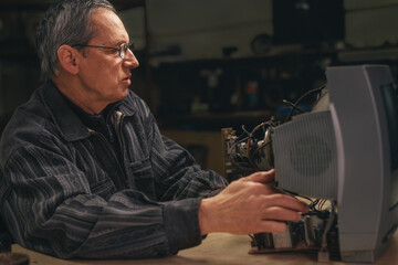 Technician inspecting deffective television