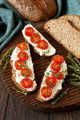 Cream cheese  with tomatoes cherry on  slice of rye bread