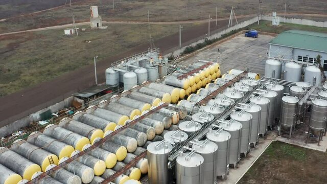 Fuel top view, drone at a small modern winery in the fall. Modern winery with large tanks for fermentation and storage of stainless steel wine. Farm, Winemaking. Drone video of the backyard