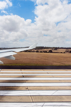 Airplane touches down at the landing strip of an Australian airport viewed from inside the plane