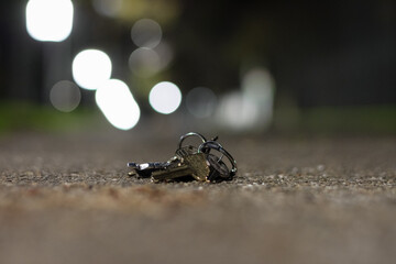 Close up of lost set of keys on a pathway at night