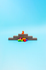 The winner stands on a pedestal above the defeated competitors and enemies, concept