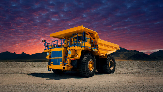 A large quarry dump truck in a coal mine. Loading coal into body work truck. Mining equipment for the transportation of minerals.