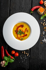 cream soup from chichevizi on a black background with decor
