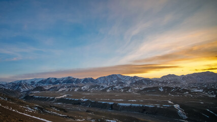 Sunset sky during winter over Altai mountain range in Govi-Altai province, Mongolia.