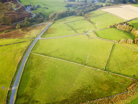 Aerial view of farmland around the road leading to Boothwood reservoir, Calderdale, West Yorkshire in the late afternoon