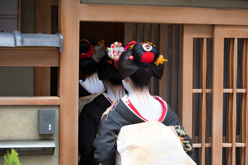 Traditional geisha and maiko out and about walking in Gion Kyoto Japan.	