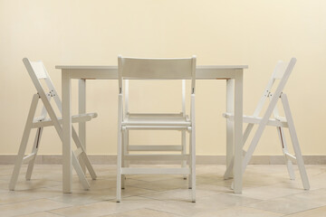 White table and folding chairs in kitchen room