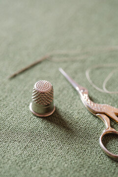Thimble with scissors, needle and thread