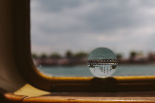 An out of focus view from a ferry with one clear sharp circle (a piece of glass).