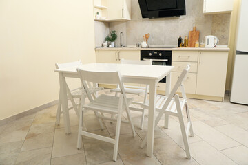 Kitchen interior with wooden table and folding chairs