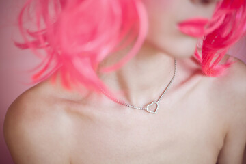 Jewelry detail on woman with pink hair