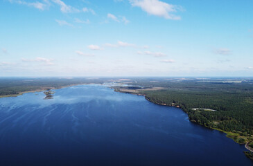 Naklejka na ściany i meble Aerial view of a beautiful calm blue forest lake