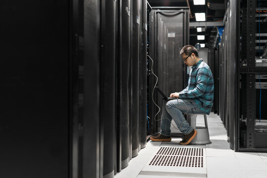 Young engineer working in datacenter