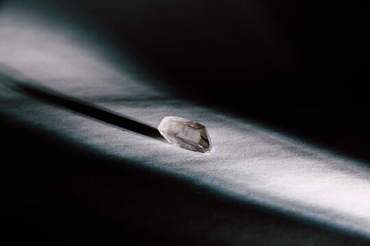 Broken Piece Of Crystal Mineral Illuminated By Beam Of Light