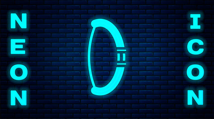 Glowing neon Medieval bow icon isolated on brick wall background. Medieval weapon. Vector.