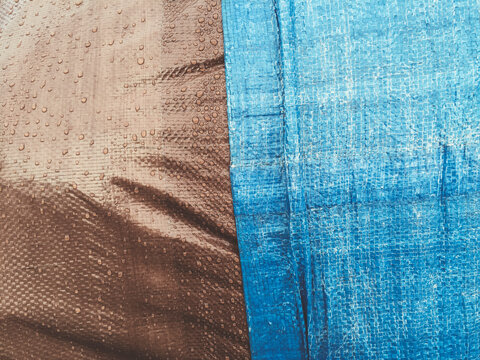 Close up of brown and blue industrial tarpaulin covering commercial fishing equipment