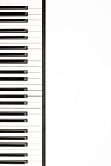 black and white piano or synthesizer keys isolated on white background, vertical shot, concept of...