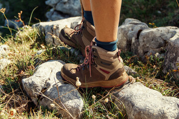  Close up of women legs wearing hiking boots in mountain