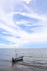 Fishing boat in the cloundy ocean