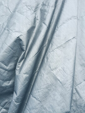 Close up of metallic, silver tarp covering commercial fishing equipment