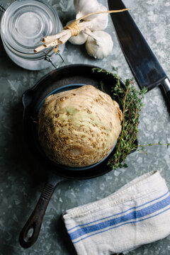 Celeriac garlic and thyme ready to be prepared for cooking.
