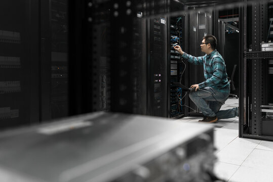 Young engineer working in datacenter