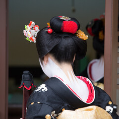 A traditional geisha out and about walking in Gion Kyoto Japan.