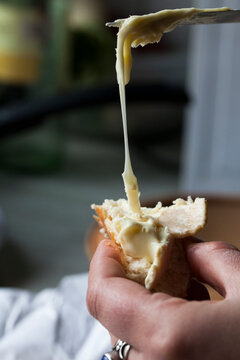 Spreading cheese on a slice of bread.