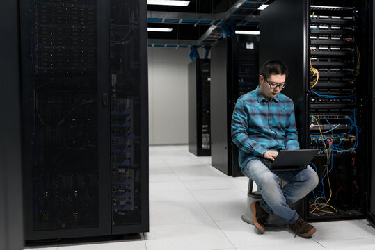 Young engineer working in datacenter