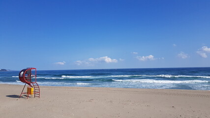person on the beach with umbrella,trip to korea