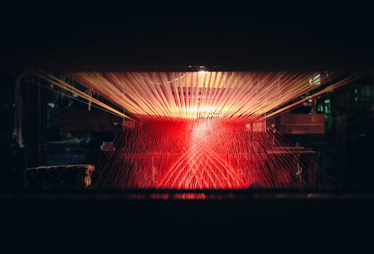 View on loom with red and pink threads