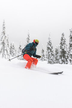 Freeride skier riding in deep snow