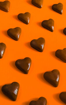 Chocolate hearts on orange background