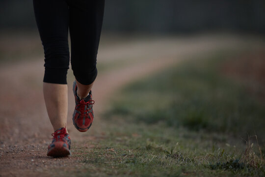 Close up of female legs and feet running outdoors