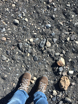 Trekking shoes on a rocky pebbly road