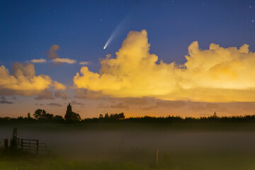 Meteor, shooting star or falling star seen in a night sky with clouds. Comet NEOWISE, C/2020 F3