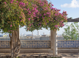 Beautiful portico of Lisbon tiled with azulejos,hand-painted ceramic tiles,overlooking the harbor and decorated with flowers.