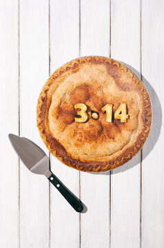 Pi: Cherry Pie With Pie Slicer On Wooden Background