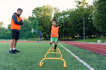Children's football players during team training before an important match. Exercises for the youth football team.