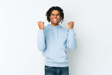Young african american rasta man cheering carefree and excited. Victory concept.