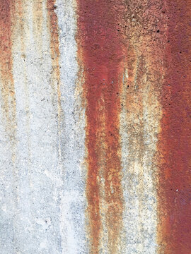 Dripping rust marks on concrete wall, close up